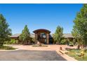 Luxurious single-story home with a grand entrance, mature trees, and circular driveway at 5603 Twilight Way, Parker, CO 80134