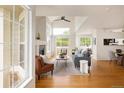 Bright living room featuring high ceilings, many windows, a fireplace, and hardwood floors at 805 Summer Hawk Dr # 100, Longmont, CO 80504