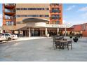 Exterior view of 100 Park Avenue West features an inviting entrance and outdoor seating area at 100 Park W Ave # 2008, Denver, CO 80205