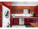 Well-equipped modern kitchen with cherry cabinets, stainless appliances, and laundry conveniently located within the space at 100 Park W Ave # 2008, Denver, CO 80205