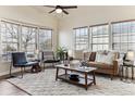 Living room with hardwood floors, large windows, and comfortable seating at 5768 Alcott St, Denver, CO 80221