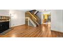 Spacious living area with a fireplace, hardwood floors, and staircase at 1209 S Flower Cir # C, Lakewood, CO 80232