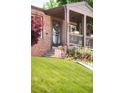 Inviting front porch with decorative details and flowers, enhancing the curb appeal of the home at 5044 W Moncrieff Pl, Denver, CO 80212