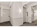 Hallway with elevator and apartment entrance, featuring neutral colors and classic design at 1365 Columbine St # 403, Denver, CO 80206