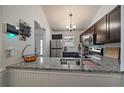 A bright, airy kitchen featuring stainless steel appliances and light granite countertops at 18902 E 17Th Ave, Aurora, CO 80011