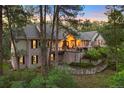 Exterior view of charming home with a covered front porch, lush landscaping, and mature trees at 315 Prospect Dr, Castle Rock, CO 80108