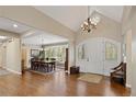A stunning foyer and dining area includes hardwood floors, vaulted ceiling, chandelier, and a bench for seating at 315 Prospect Dr, Castle Rock, CO 80108