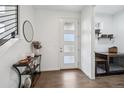 Bright foyer featuring hardwood floors, modern console table, and a stylishly framed mirror at 8331 Farmers Way, Highlands Ranch, CO 80129