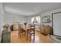 Bright dining room with hardwood floors, natural light, and charming, rustic decor at 10978 W Ada Pl, Lakewood, CO 80226