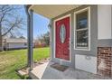Inviting front entrance featuring a striking red door with decorative glass and a well-kept front lawn at 5190 S Emporia Way, Greenwood Village, CO 80111