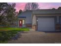 Home exterior featuring a red front door, attached garage, and well-maintained lawn with an inviting appeal at 5190 S Emporia Way, Greenwood Village, CO 80111