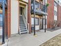 Exterior view of an apartment entrance showing stairs and a balcony with a bicycle hanging on the railing at 5995 W Hampden Ave # 23, Denver, CO 80227