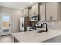 Spacious kitchen with stainless steel appliances, white countertops, and modern fixtures at 18318 E 93Rd Pl, Commerce City, CO 80022