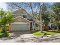 Charming two-story home featuring a stone facade, attached garage, and well-manicured lawn at 10519 Winterflower Way, Parker, CO 80134