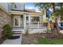 Cozy front porch with white railings, bay window, and well-maintained landscaping at 10519 Winterflower Way, Parker, CO 80134
