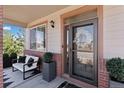 Charming covered front porch with seating area, modern decor, and pleasant curb appeal at 1301 Sidewinder Cir, Castle Rock, CO 80108