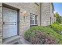 Inviting entrance with brick facade, decorative door, and well-maintained landscaping at 5511 S Lowell Blvd, Littleton, CO 80123