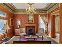 Sophisticated living room with a decorative fireplace, chandelier and classic furnishings at 1345 N Franklin St, Denver, CO 80218