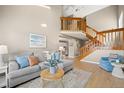 Comfortable living room featuring a staircase, neutral tones, and stylish furnishings at 14822 E Penwood Pl # D, Aurora, CO 80015