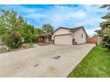 Spacious home exterior featuring an attached garage and large driveway at 1828 Stratford Ln, Longmont, CO 80503