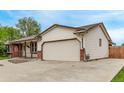 Spacious home exterior featuring an attached garage and lovely landscaping at 1828 Stratford Ln, Longmont, CO 80503