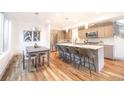 Bright kitchen with stainless steel appliances, island with seating, and adjacent dining area, creating an inviting space at 822 Fairfax St, Denver, CO 80220
