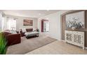 Cozy living room featuring neutral carpet, comfortable seating, and an inviting, light-filled atmosphere at 10722 W 54Th Pl, Arvada, CO 80002