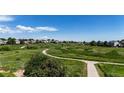 Scenic view of a community walking path with lush greenery and open space at 10533 Redcone Way, Highlands Ranch, CO 80130
