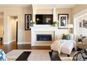 Comfortable living room with a modern fireplace, white mantel, and stylish decor at 12371 Red Fox Way, Broomfield, CO 80021