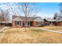 Lovely brick home with a blue door, complemented by a green lawn and traditional design at 1780 Roslyn St, Denver, CO 80220