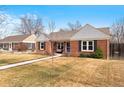 Quaint brick home with a tidy front yard, showcasing classic architecture and curb appeal at 1780 Roslyn St, Denver, CO 80220