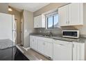Bright kitchen with white cabinets, granite countertops, and stainless steel appliances at 4710 E Louisiana Ave, Denver, CO 80246