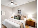 Comfortable bedroom with a ceiling fan, two bedside tables and soft, natural light at 2240 N Clay St # 309, Denver, CO 80211