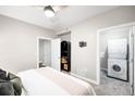 Clean bedroom with a ceiling fan and a laundry closet with stacked washer and dryer units at 2240 N Clay St # 309, Denver, CO 80211