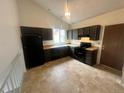 Eat-in kitchen features dark cabinets, modern appliances and a tiled floor at 19351 E Purdue Cir, Aurora, CO 80013