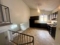 Eat-in kitchen features dark cabinets, modern appliances and a tiled floor at 19351 E Purdue Cir, Aurora, CO 80013