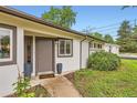 Inviting front entrance with a pathway, garden, and modern door at 845 Everett St, Lakewood, CO 80215