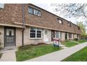 View of townhouse exteriors featuring well-manicured lawns and beautiful brick facades at 13043 W 20Th Ave, Golden, CO 80401