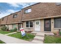 Charming townhouse exterior with beautiful brick facade and well-manicured green lawn at 13043 W 20Th Ave, Golden, CO 80401