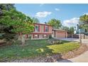 Attractive two-story home with neat landscaping and a spacious front yard leading to a driveway and garage at 11112 Dahlia Way, Thornton, CO 80233