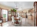 Bright dining area with hardwood floors, built-ins, and views at 46303 E 106Th Ave, Bennett, CO 80102