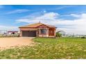 Charming tan single story home with well-manicured lawn at 46303 E 106Th Ave, Bennett, CO 80102