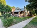 Brick house with a charming porch and well-maintained lawn at 1731 E 25Th Ave, Denver, CO 80205