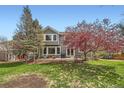 Backyard featuring lush green lawn, mature trees, and a patio area perfect for outdoor entertaining at 11321 Mesa Verde Pl, Parker, CO 80138
