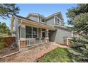 Charming home featuring neutral siding, a cozy front porch with decorative columns, and manicured landscaping at 11321 Mesa Verde Pl, Parker, CO 80138