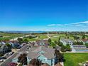Scenic aerial view of a community with green spaces, blue buildings, and mountain views at 2550 S Cutters Cir # 105, Castle Rock, CO 80108