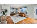 Bright living room with hardwood floors, a leather couch, and a coffee table at 4770 S Jason St, Englewood, CO 80110