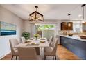 Elegant dining room with a table for six and sliding glass doors to the patio at 9026 E Mansfield Ave, Denver, CO 80237