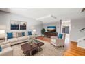 Bright living room with hardwood floors and a staged seating area at 9026 E Mansfield Ave, Denver, CO 80237