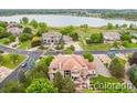 Stunning aerial view of a lakeside home with lush landscaping and a circular driveway at 14154 Lexington Cir, Westminster, CO 80023